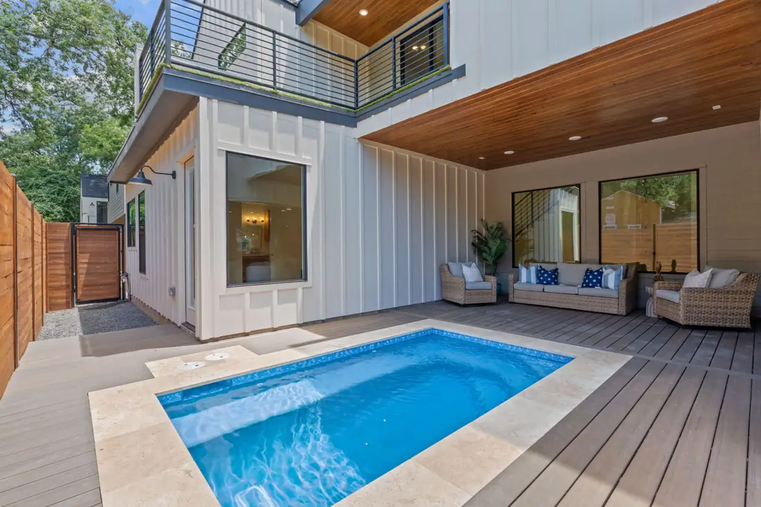 Plunge pool and covered patio with a wood soffit at a Holly St home