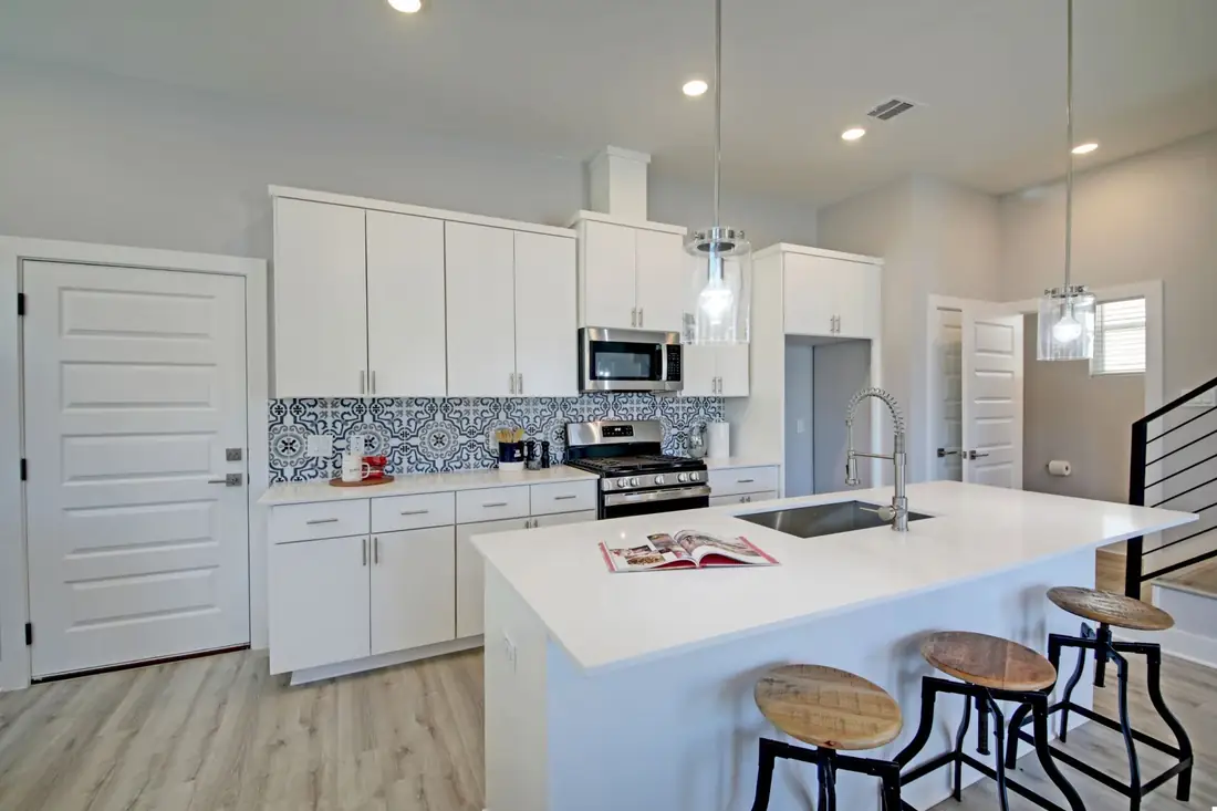 Island kitchen with patterned tile and pendant lights on Meador Ave