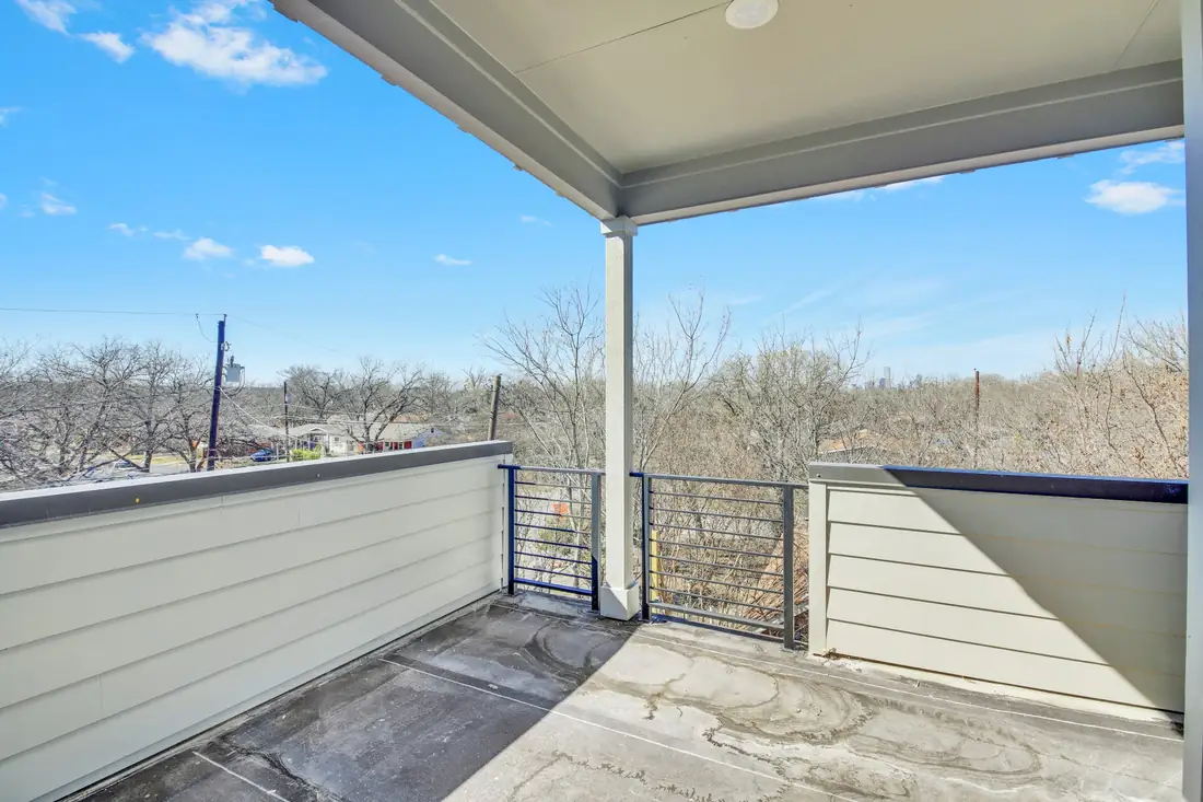 Covered upper balcony with a steel railing