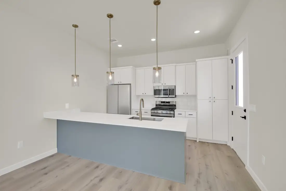 Kitchen with a slate-grey island and white cabinets