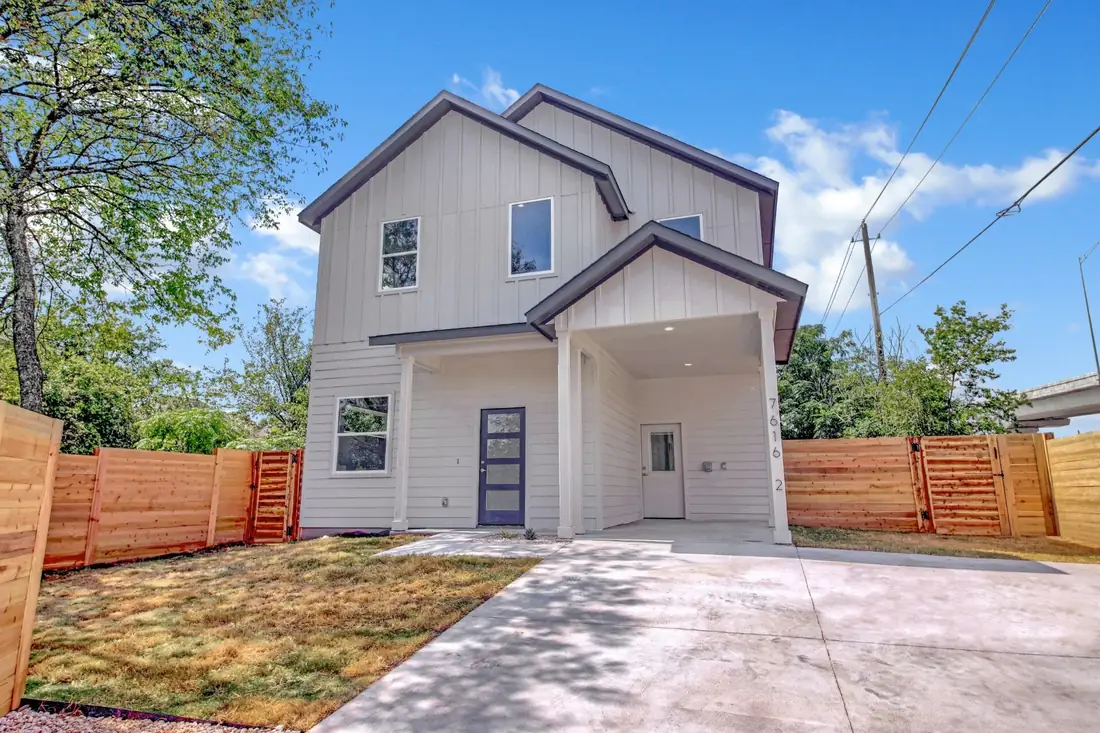 White two-storey home on Providence Ave with a cedar fence
