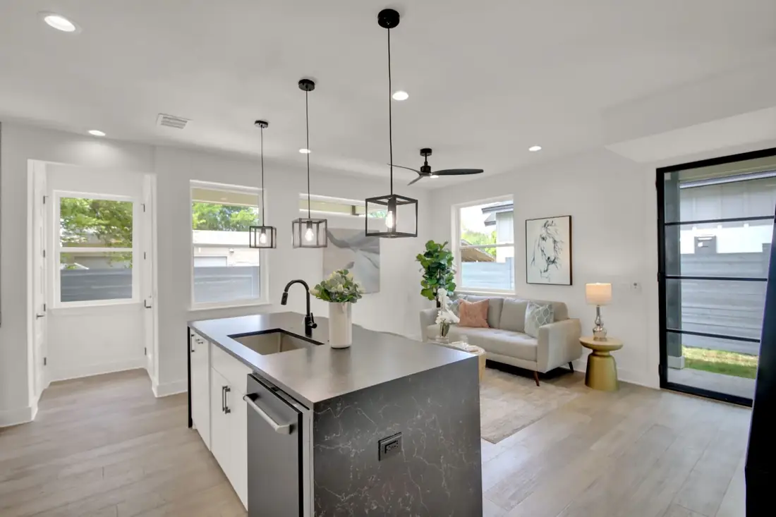 White kitchen with a dark island and black pendants on S 2nd St